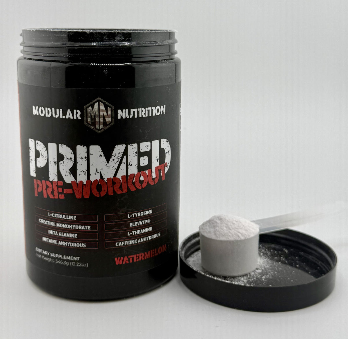 Primed Pre-Workout jar with the lid off and a heaped scoop of pink watermelon powder
